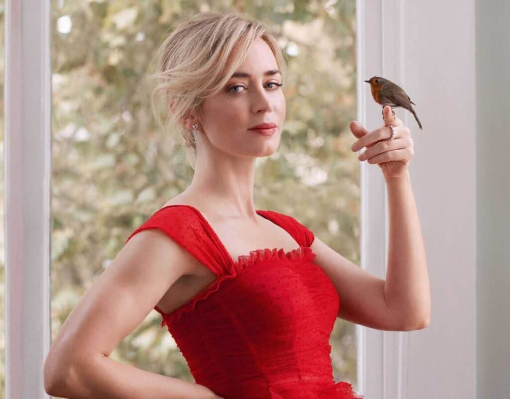 Emily Blunt wearing red dress with a bird