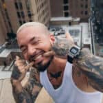 J Balvin sitting on rooftop