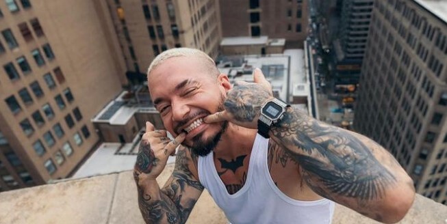 J Balvin sitting on rooftop