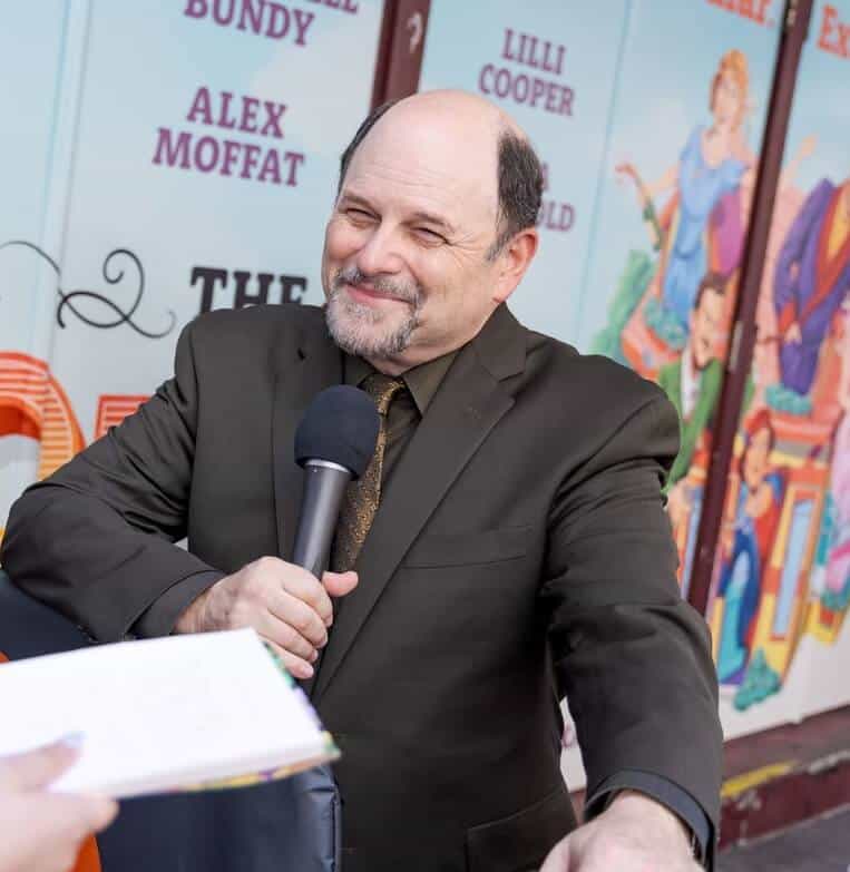 Jason Alexander holding mic