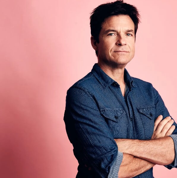 Jason Bateman posing against a wall