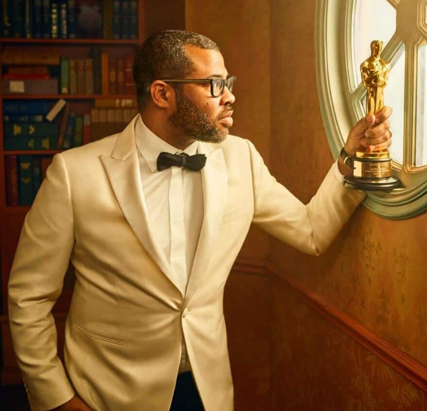 Jordan Peele holding Award