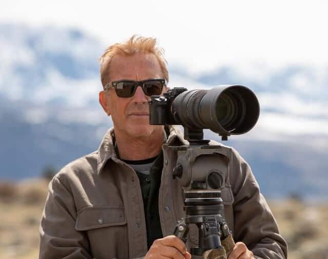 Kevin Costner shooting objects with camera