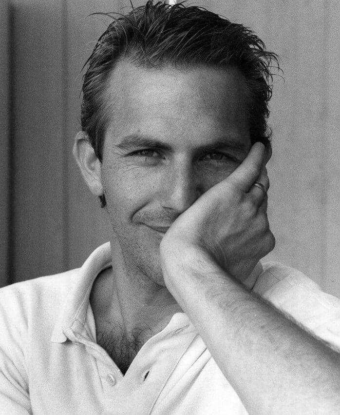 Kevin Costner with his hand on face