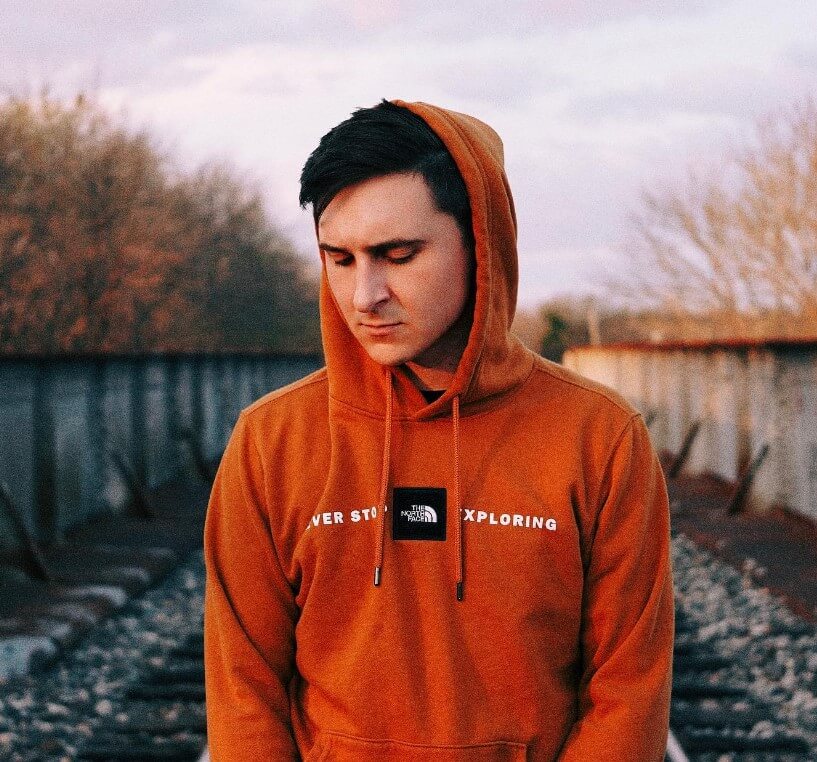 Mitchel Musso wearing orange hoodie