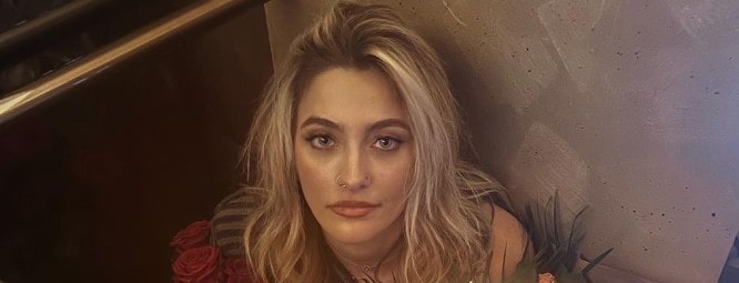 Paris Jackson holding flower bouquet
