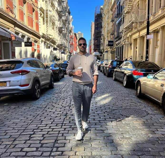 Ramit Sethi walking on street holding morning coffee