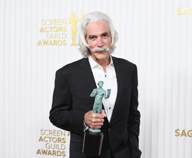 Sam Elliott holding Award