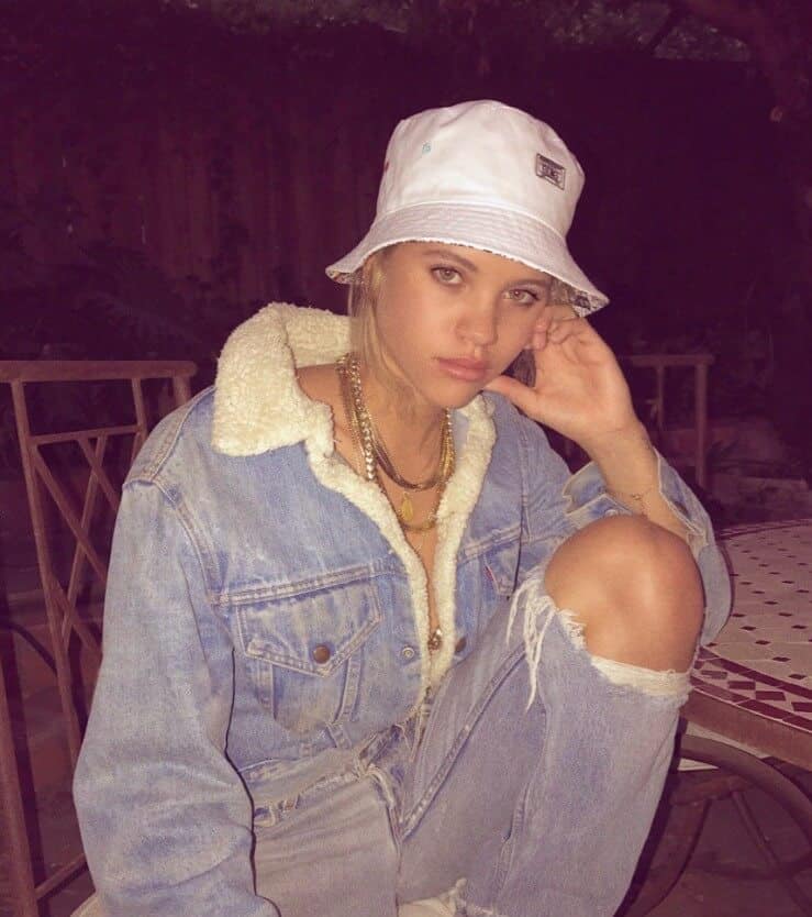 Sofia Richie wearing white hat and denim